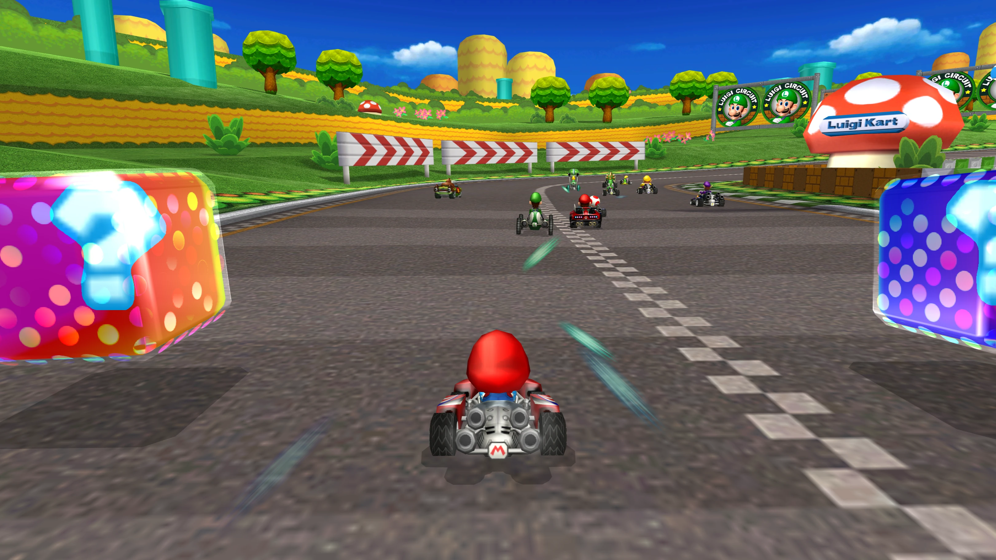 Mario driving between nearby item boxes, with other racers and hills farther along Luigi Circuit.